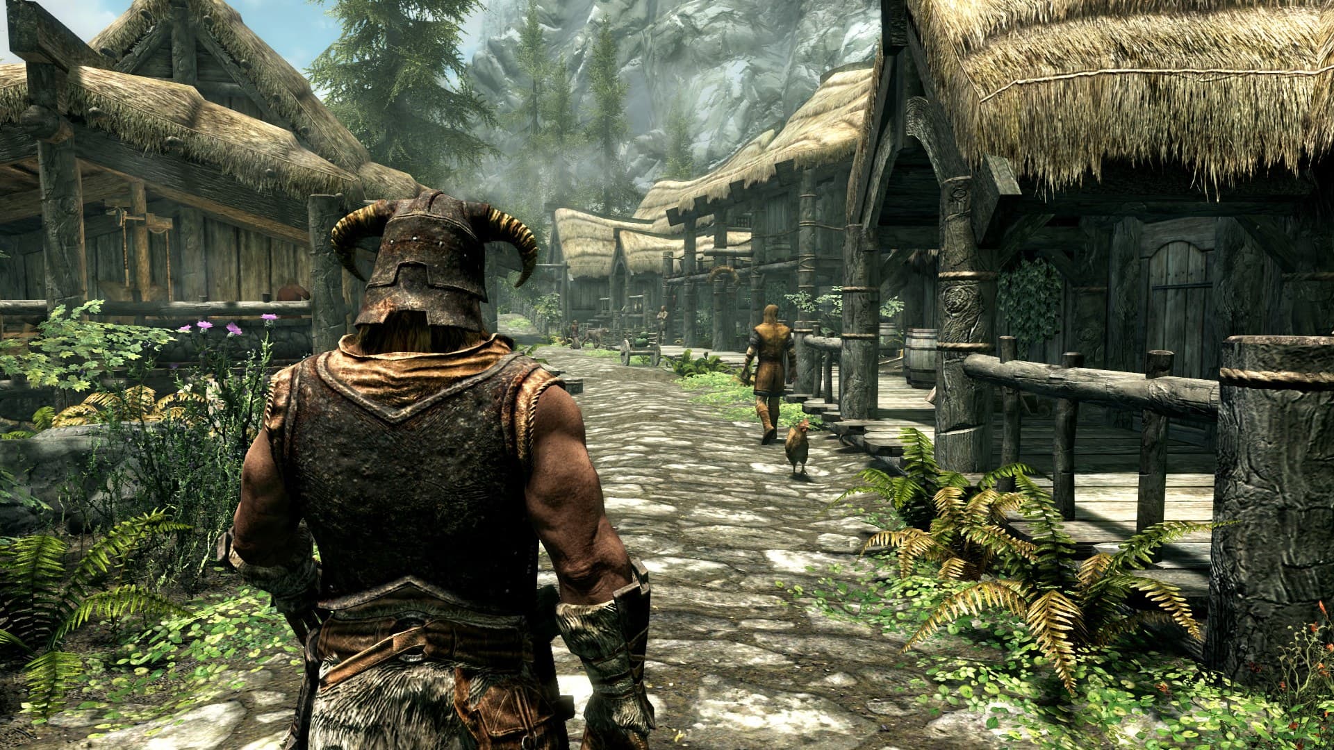 O Dragonborn, de capacete com chifres, caminha por uma rua de vila em Skyrim