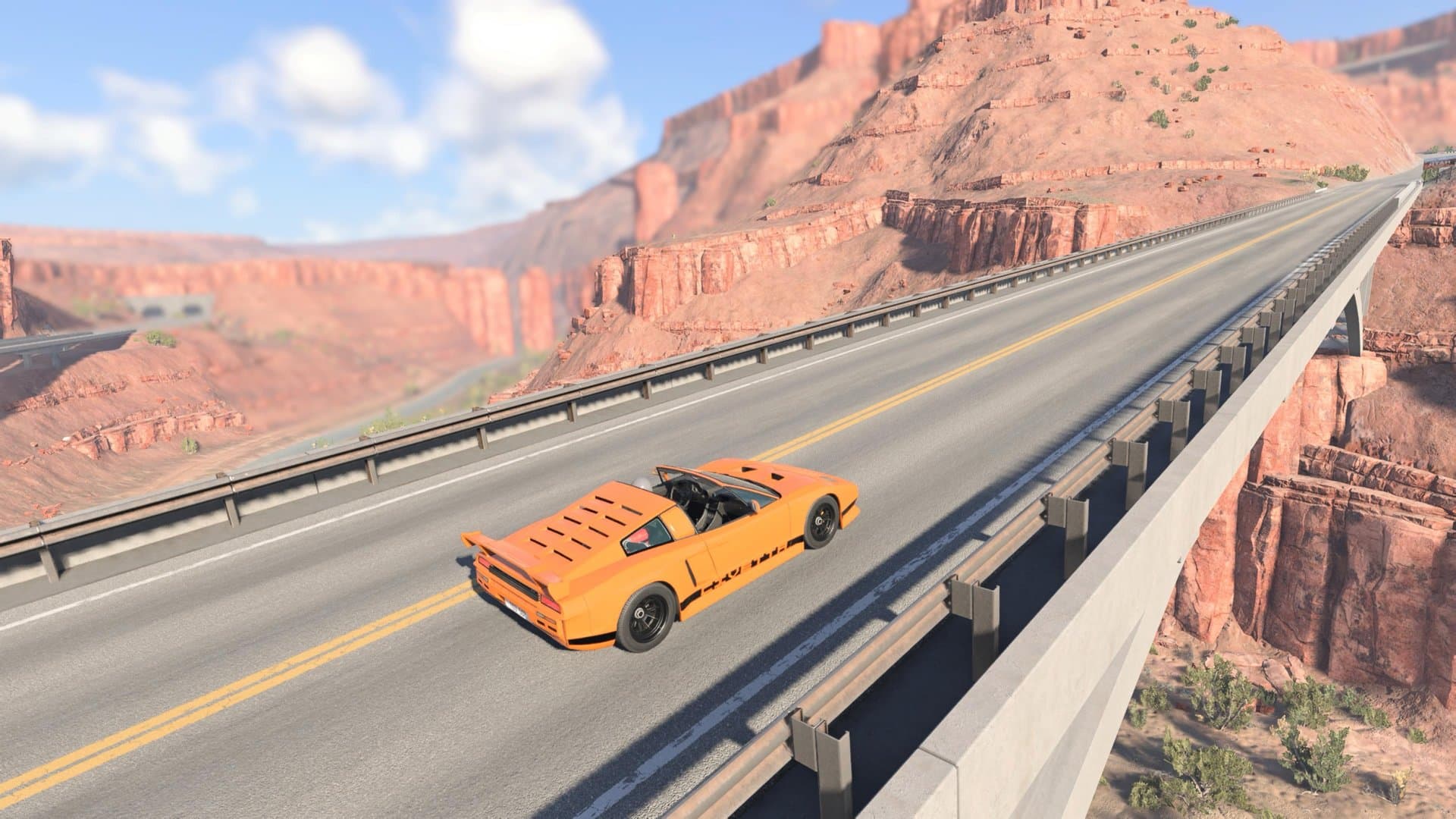 Um esportivo conversível laranja cruza uma ponte entre os cânions do Utah. Captura feita pelo Acerto Games no PS5.